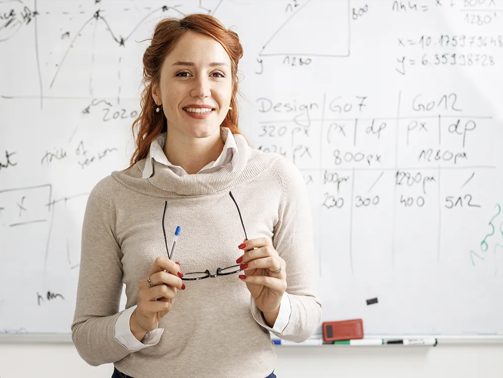 Female faculty member smiling in front of white board