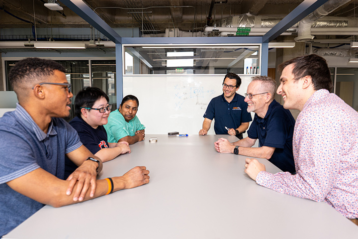 faculty member Anthony Rios having a discussion with students