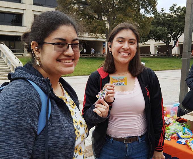 UTSA students holding stickers with motivational messages